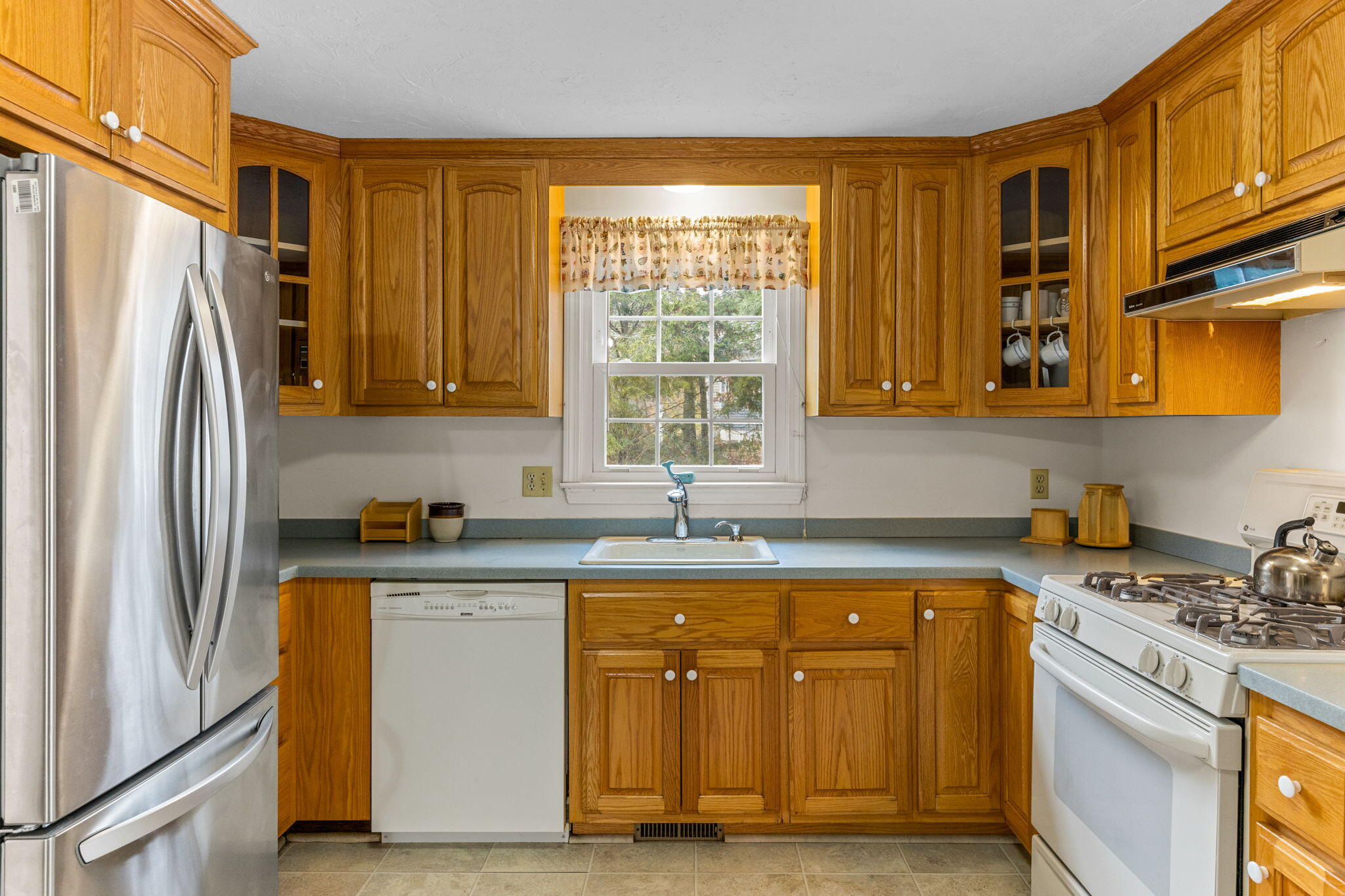 93 Valley Bars Road Buzzards Bay, MA 02532 - Photo 11 of 34 a kitchen with stainless steel appliances granite countertop a refrigerator and a stove top oven