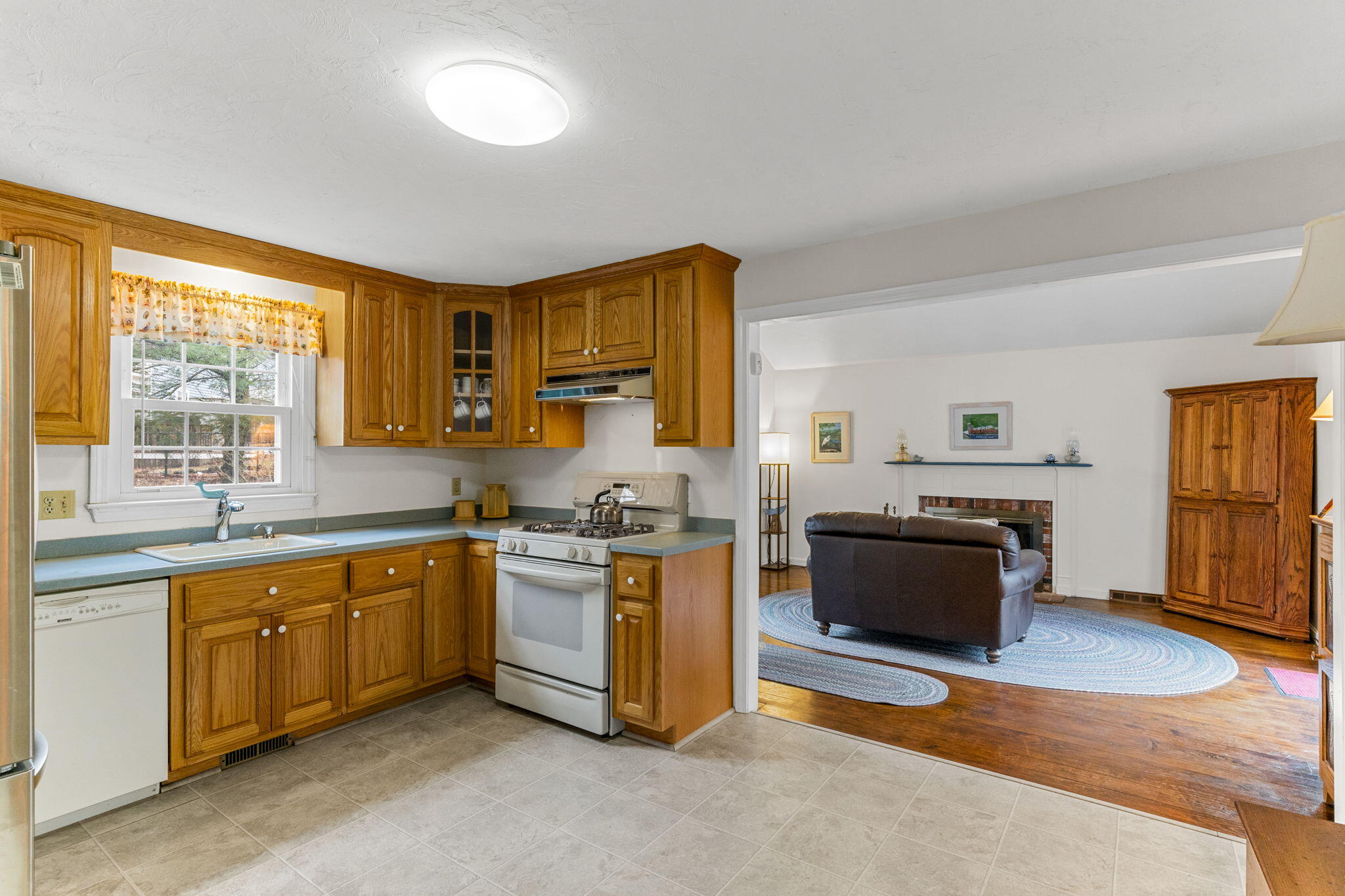 93 Valley Bars Road Buzzards Bay, MA 02532 - Photo 10 of 34 a kitchen with stainless steel appliances granite countertop a stove top oven a sink dishwasher and a refrigerator with wooden floor