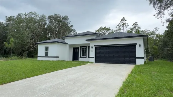 a front view of a house with a yard and garage