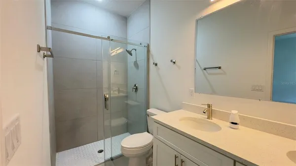 a bathroom with a sink toilet and shower