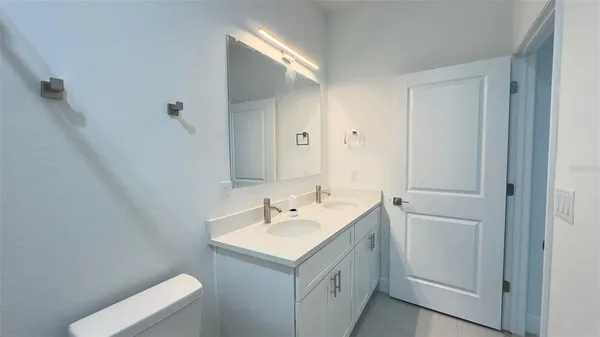 a bathroom with a sink toilet and vanity