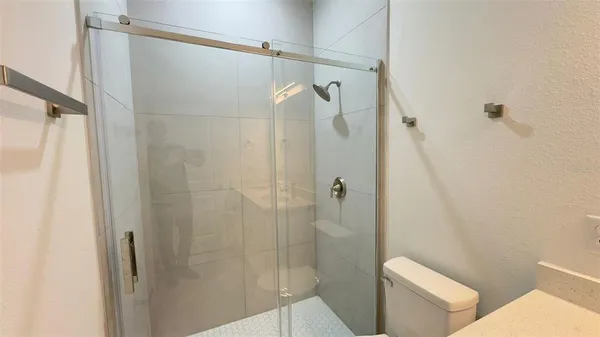 a bathroom with a shower and toilet