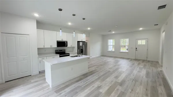 a view of a kitchen with electric appliances