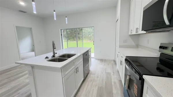 a kitchen with a stove and a sink