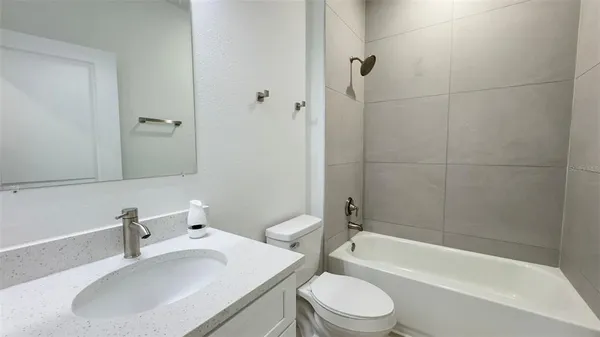 a bathroom with a toilet a sink and bathtub
