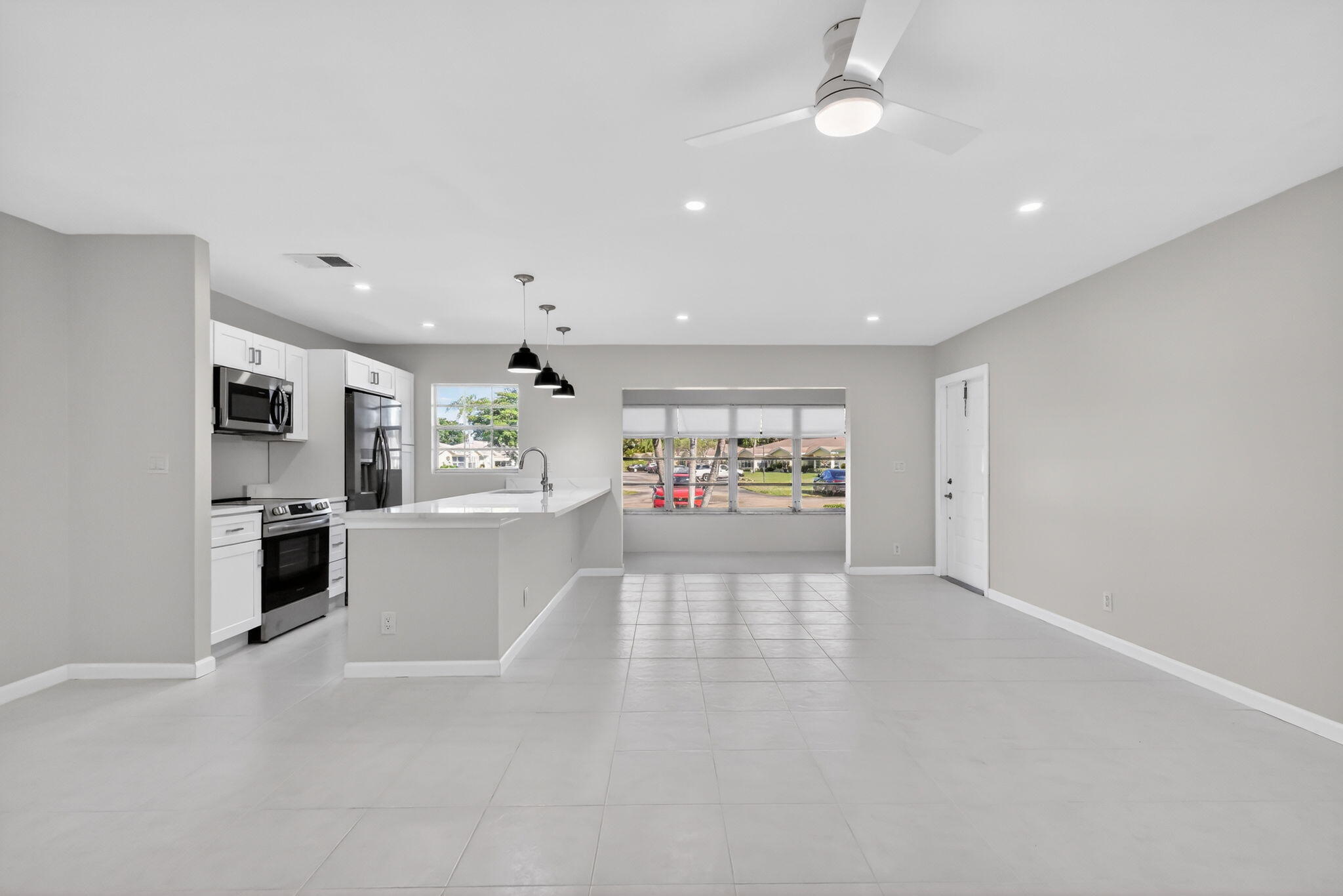 14280 Nesting Way, Unit B Delray Beach, FL 33484 - Photo 15 of 43 a view of a kitchen with refrigerator and white cabinets