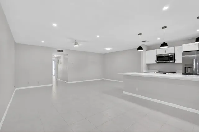 a view of a kitchen with microwave and cabinets