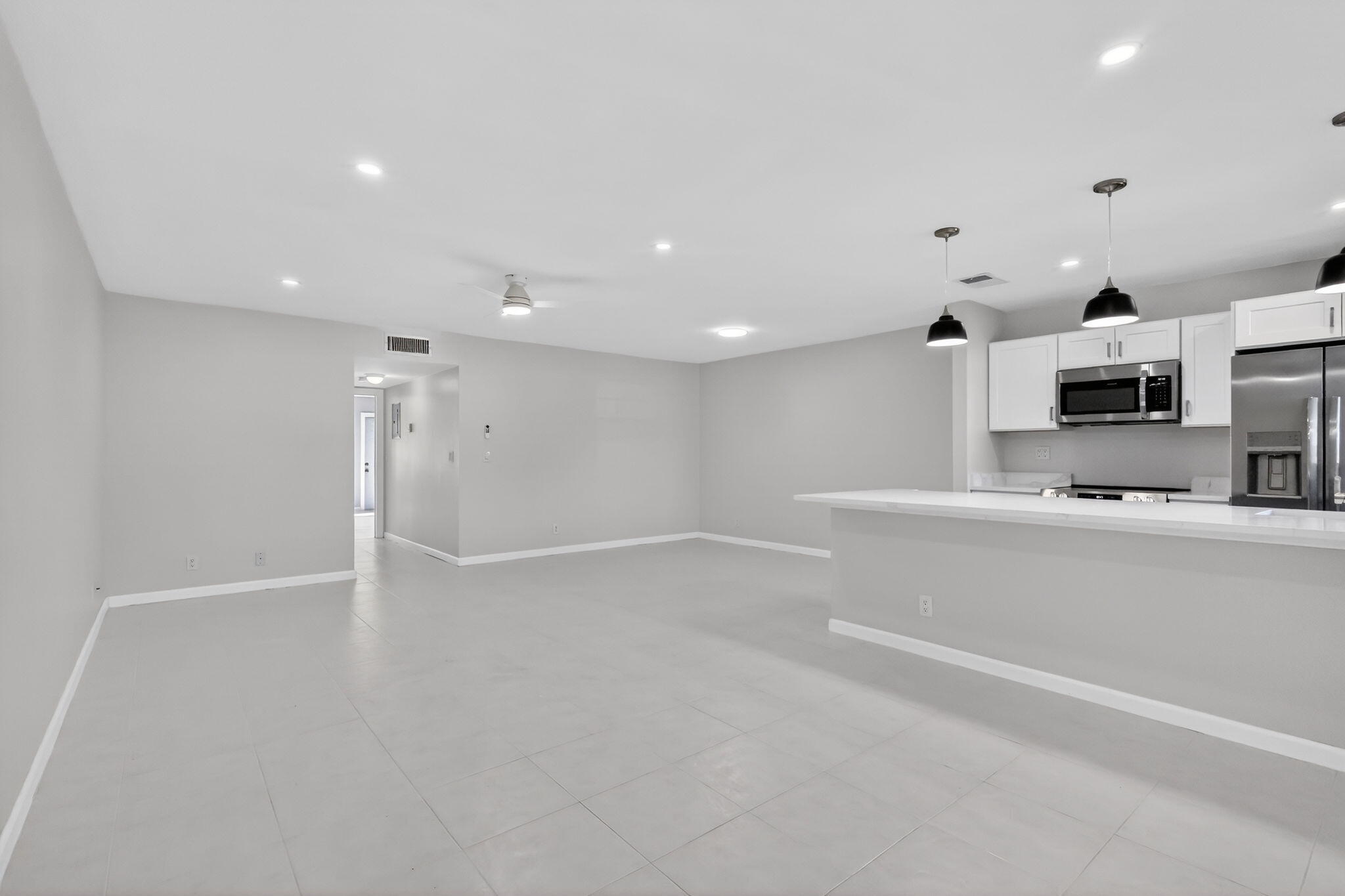 14280 Nesting Way, Unit B Delray Beach, FL 33484 - Photo 2 of 43 a view of a kitchen with microwave and cabinets