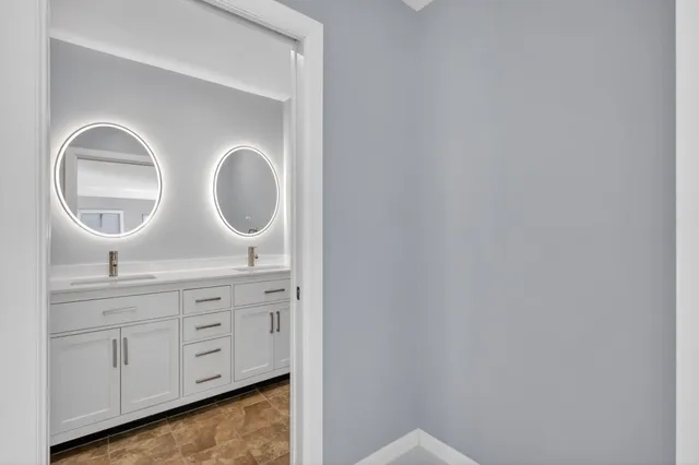 a bathroom with a sink a toilet and a mirror