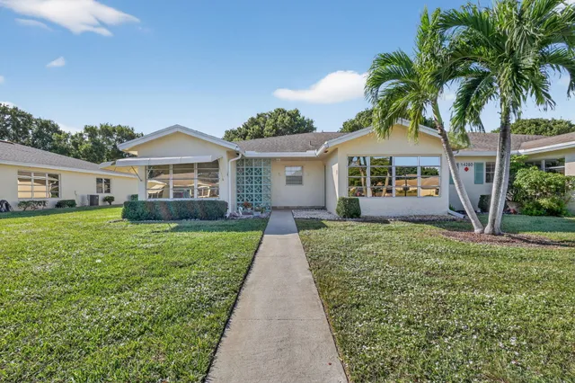 an aerial view of a tennis ground and a yard