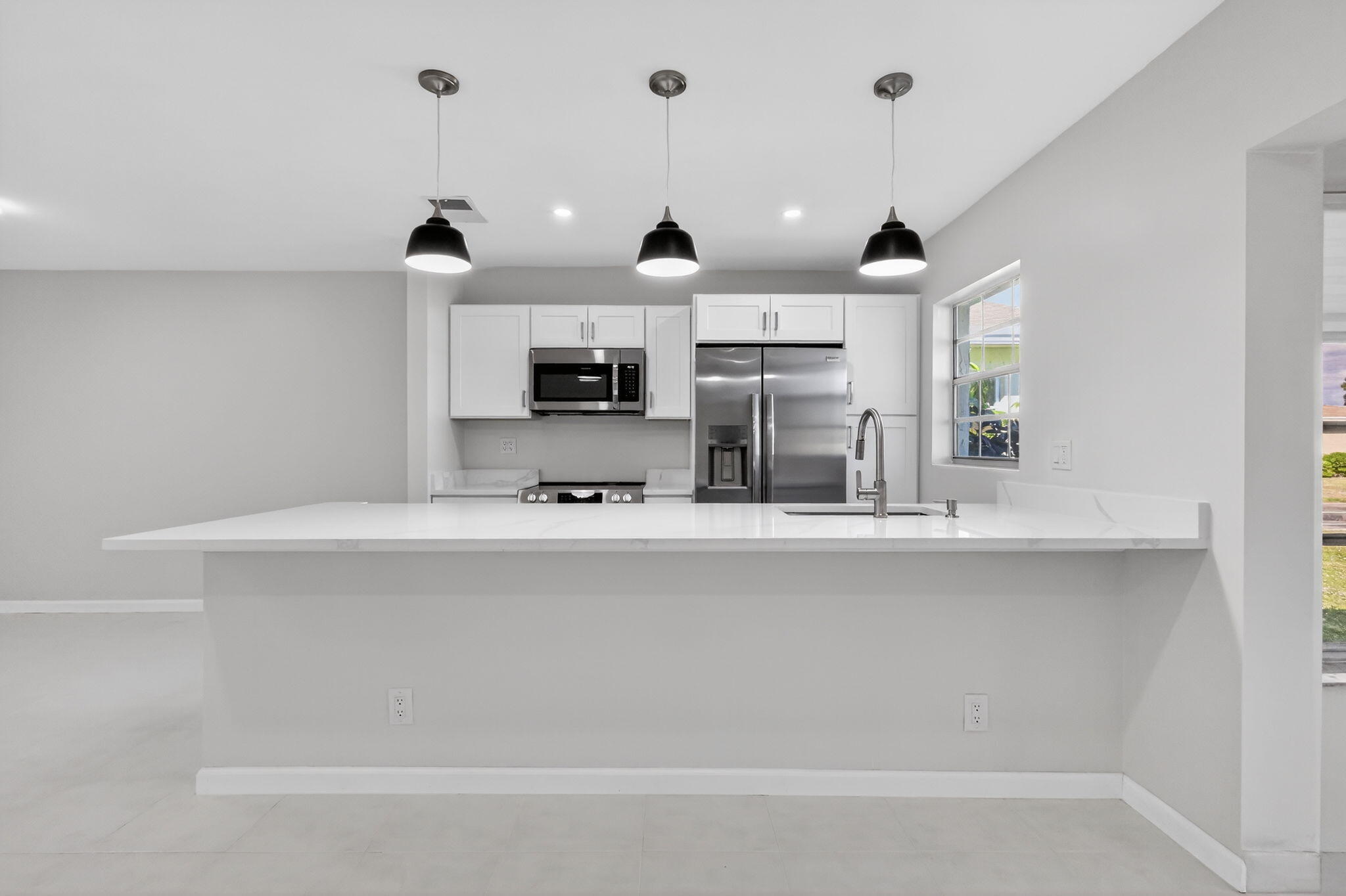 14280 Nesting Way, Unit B Delray Beach, FL 33484 - Photo 9 of 43 a view of kitchen with sink and microwave
