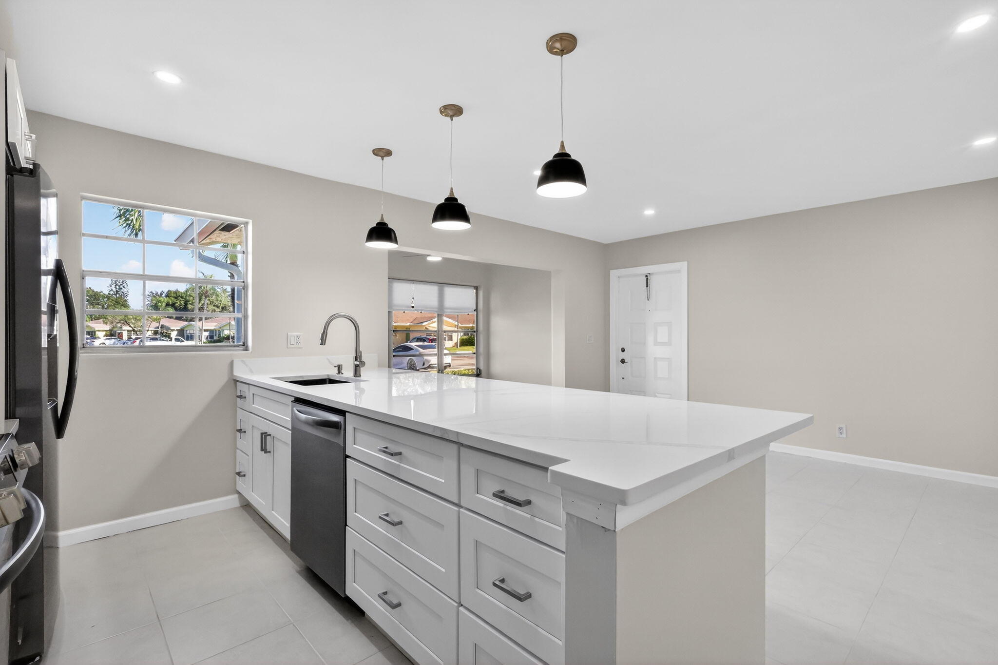 14280 Nesting Way, Unit B Delray Beach, FL 33484 - Photo 10 of 43 a kitchen with white cabinets and sink