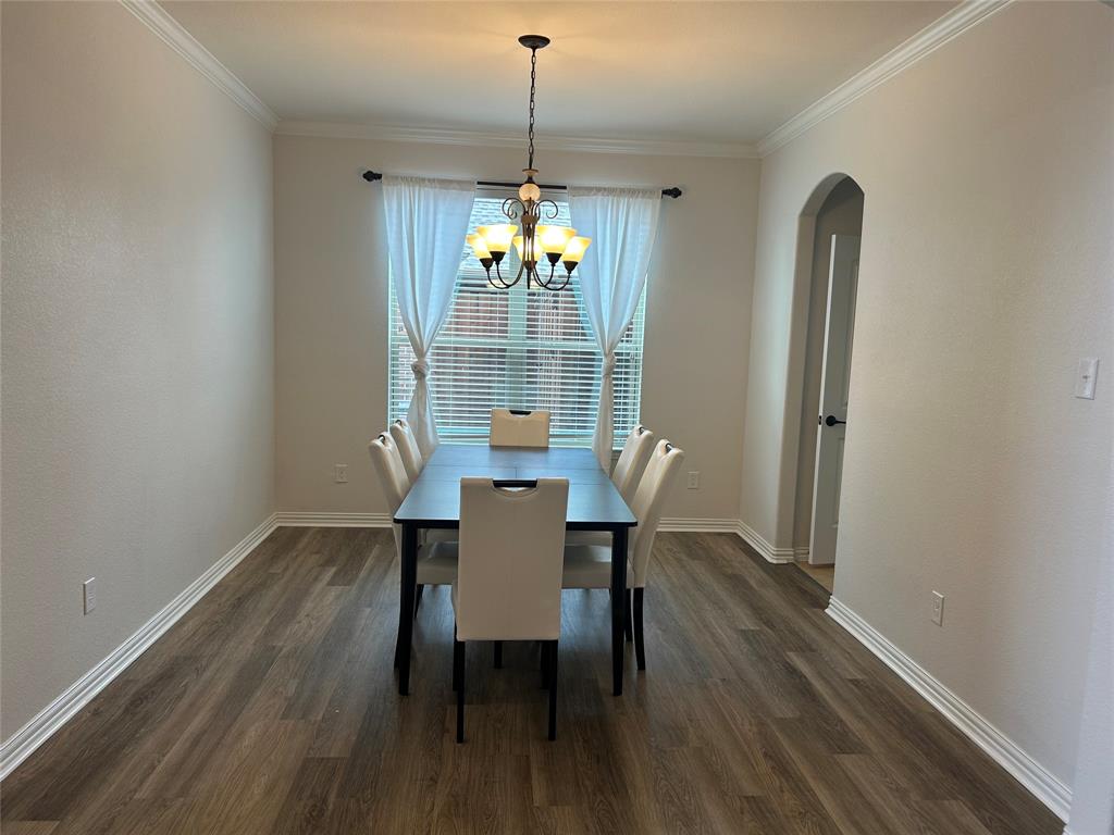 16117 Harper Road Prosper, TX 75078 - Photo 2 of 8 a dining room with furniture a chandelier and wooden floor