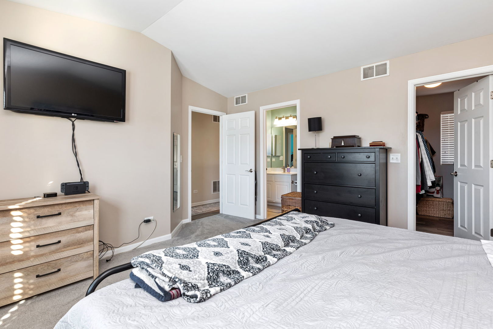 5003 Syracuse Court Plainfield, IL 60586 - Photo 13 of 18 a bedroom with a bed and a flat screen tv