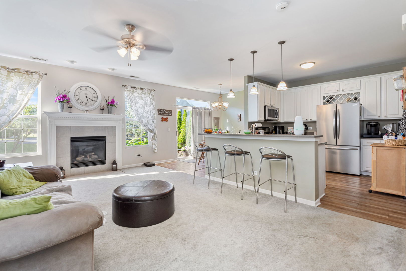 5003 Syracuse Court Plainfield, IL 60586 - Photo 4 of 18 a large white kitchen with a refrigerator a stove a dining table and chairs