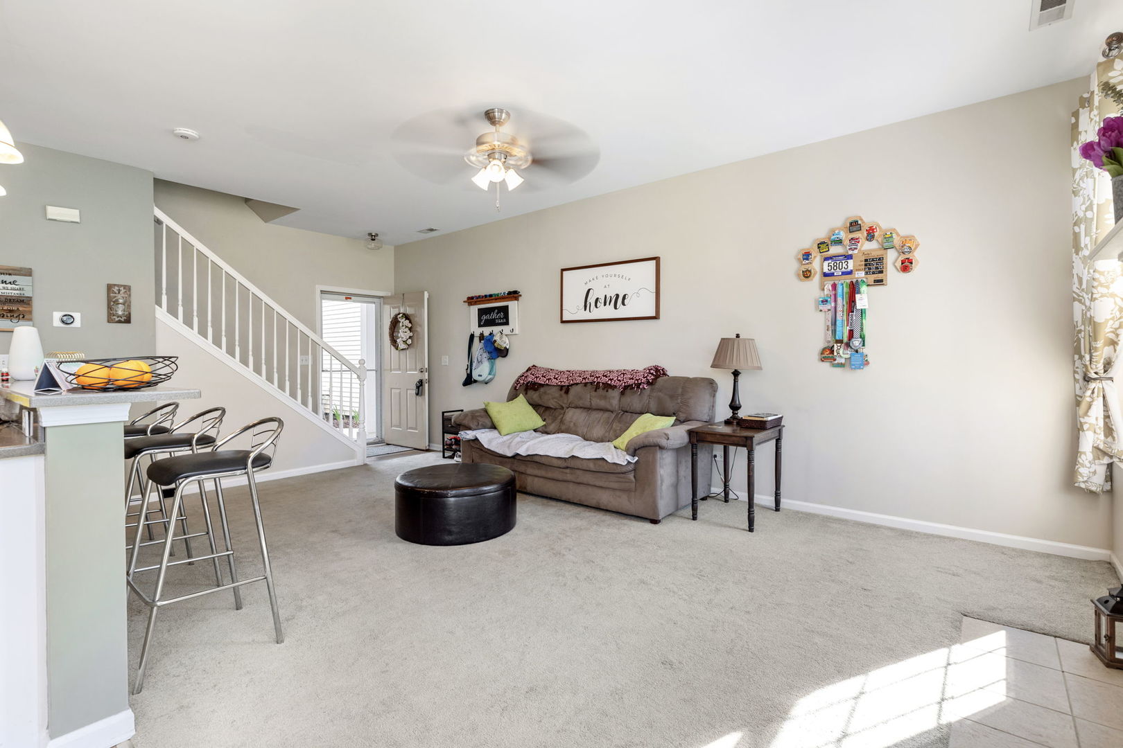 5003 Syracuse Court Plainfield, IL 60586 - Photo 5 of 18 a living room with furniture and stairs