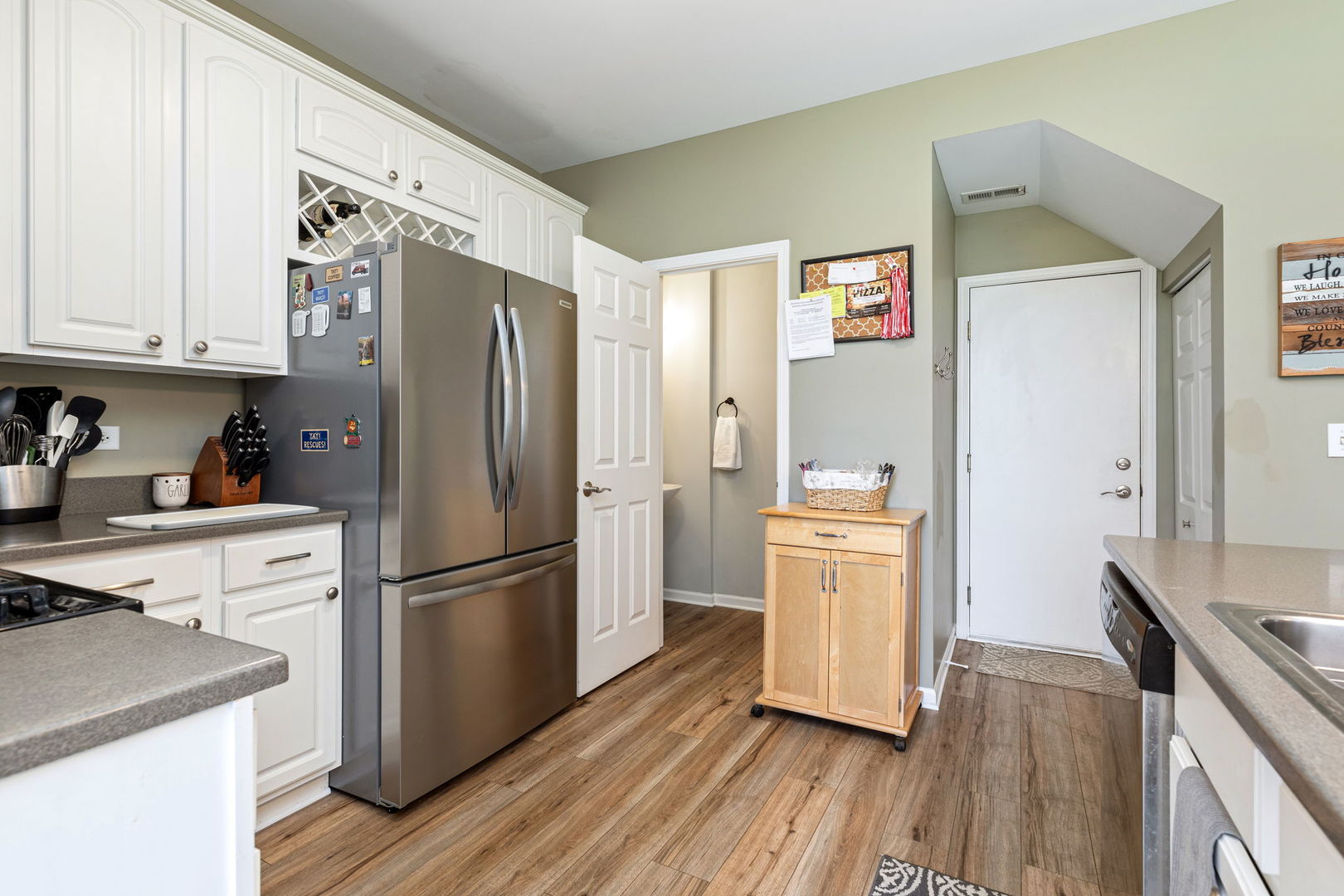 5003 Syracuse Court Plainfield, IL 60586 - Photo 8 of 18 a kitchen with a refrigerator cabinets and wooden floor
