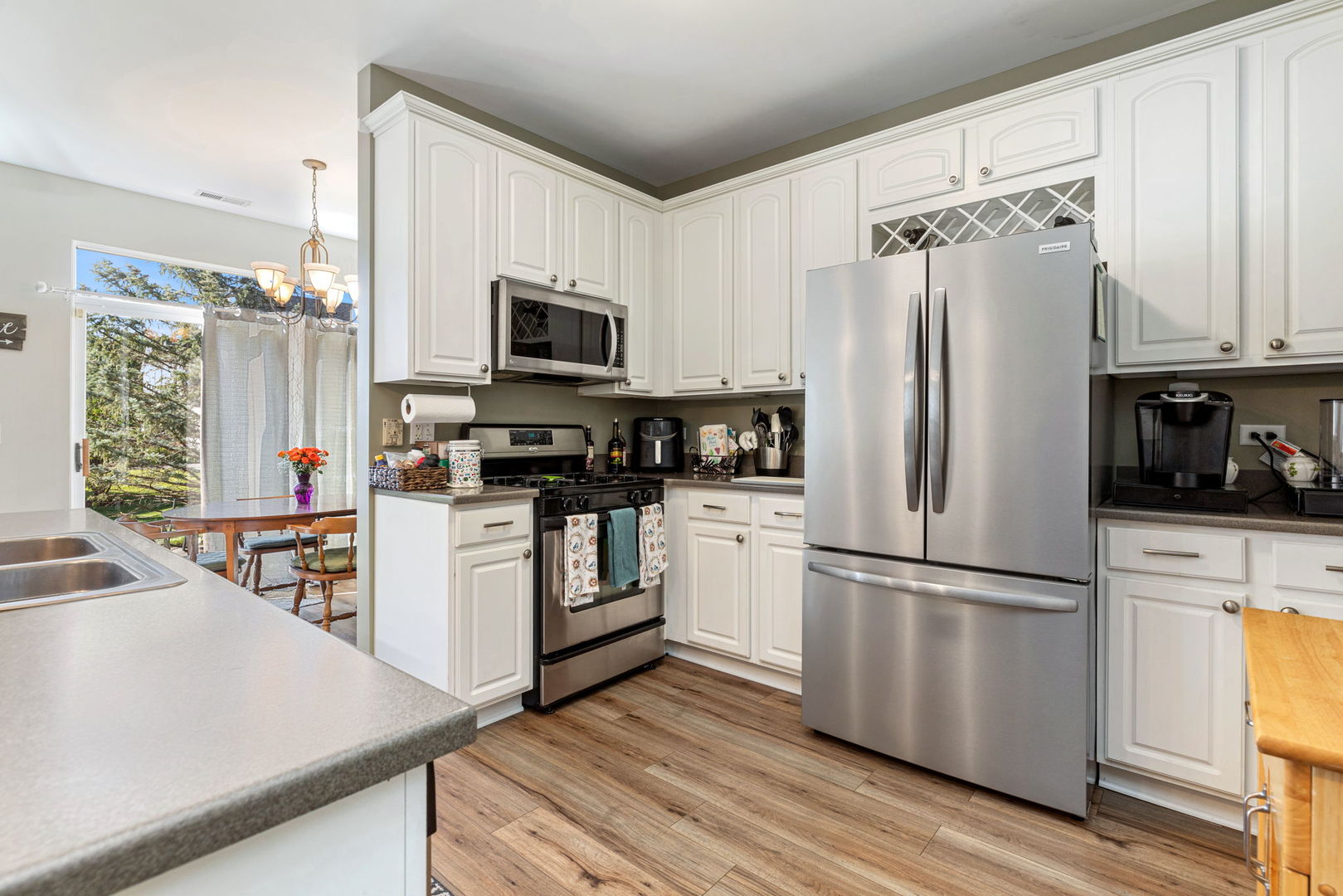 5003 Syracuse Court Plainfield, IL 60586 - Photo 10 of 18 a kitchen with cabinets stainless steel appliances and wooden floor