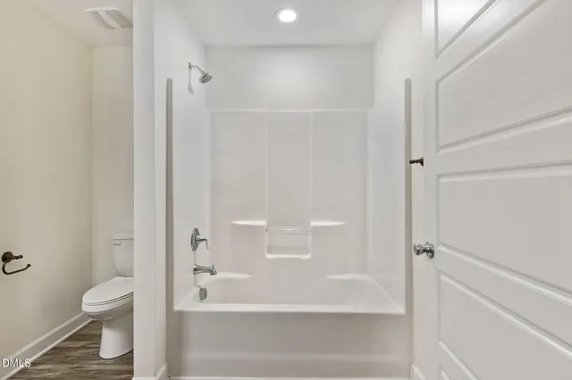 a bathroom with a bathtub and a toilet