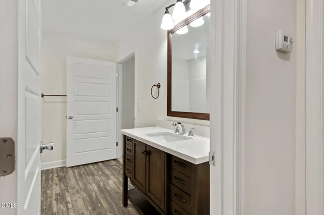 a bathroom with a sink vanity and mirror