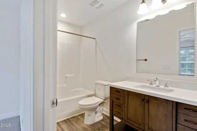 a bathroom with a sink toilet a mirror and shower