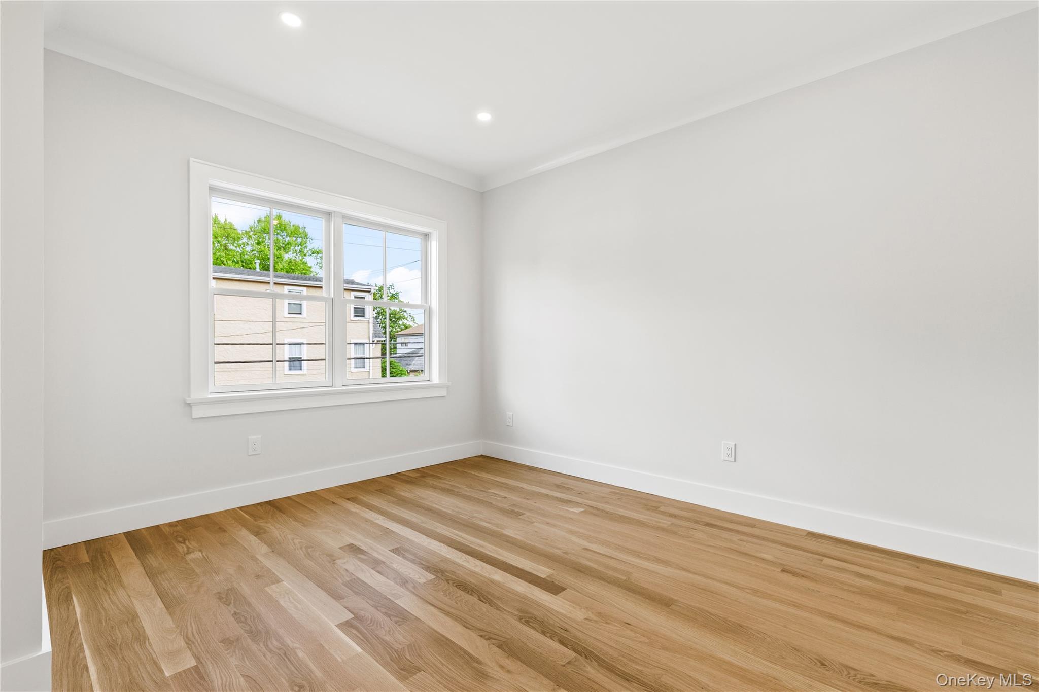 86 B Maple Street Rye, NY 10580 - Photo 12 of 33 an empty room with wooden floor and windows