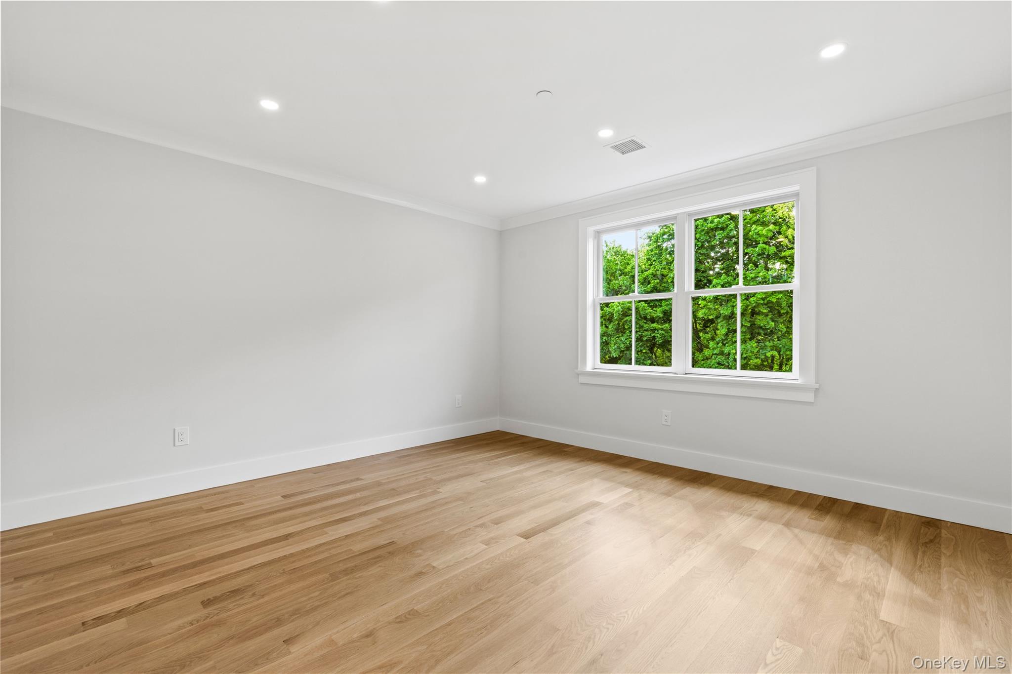 86 B Maple Street Rye, NY 10580 - Photo 18 of 33 an empty room with wooden floor and windows