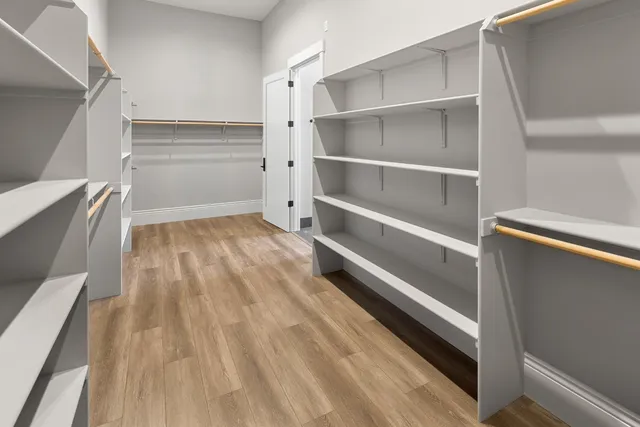 a view of walk in closet with empty racks
