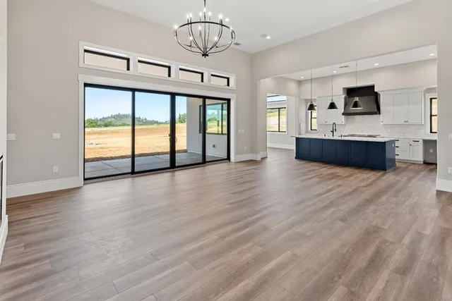 a living room with stainless steel appliances kitchen island granite countertop furniture and a flat screen tv