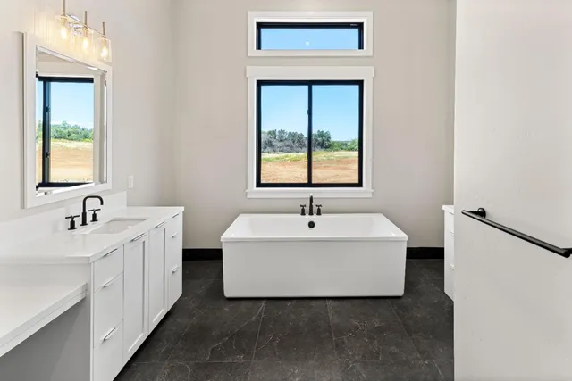 a white bath tub sitting next to a white sink