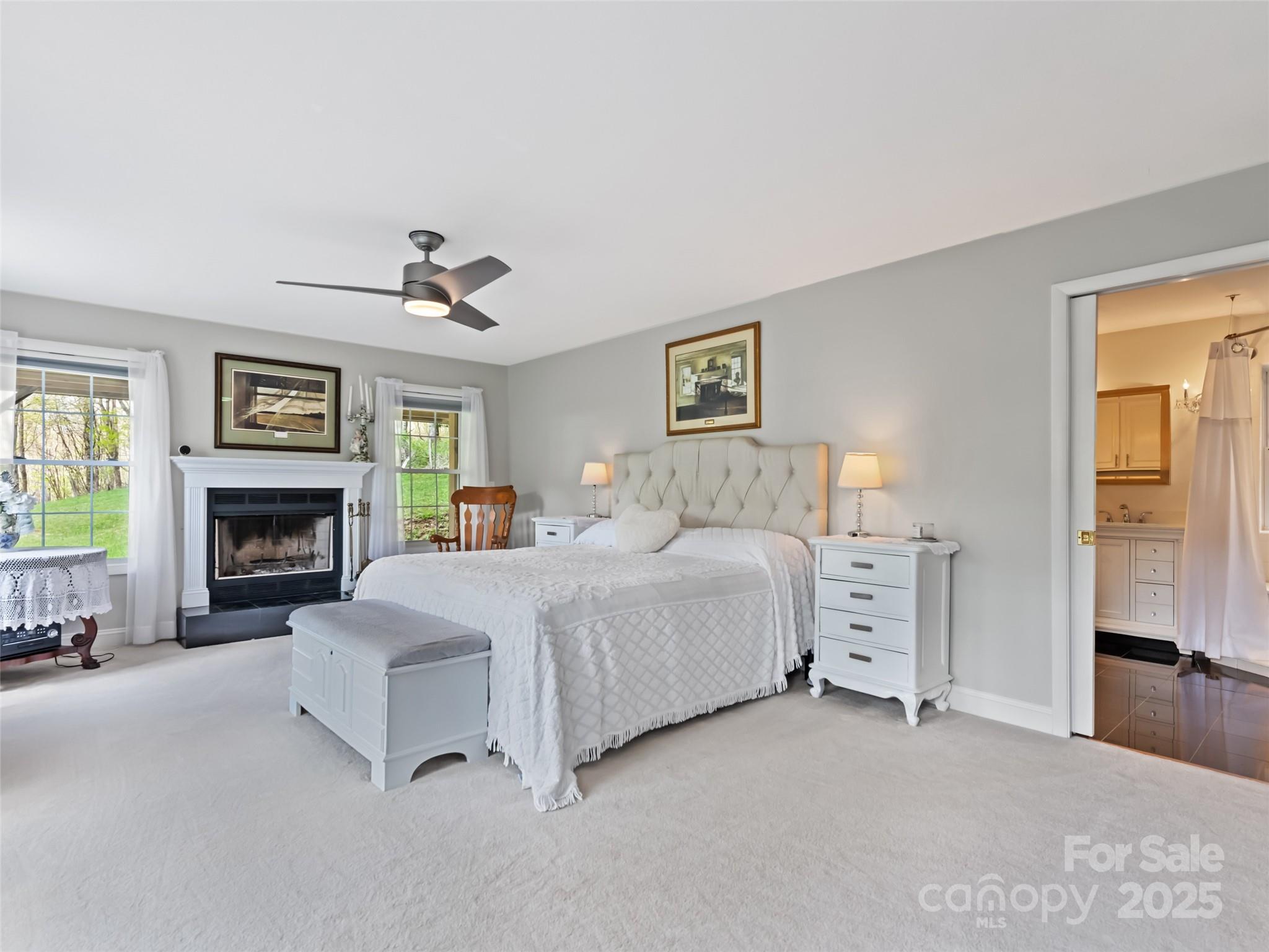 6780 Max Patch Road Clyde, NC 28721 - Photo 11 of 32 a spacious bedroom with a bed and a fireplace