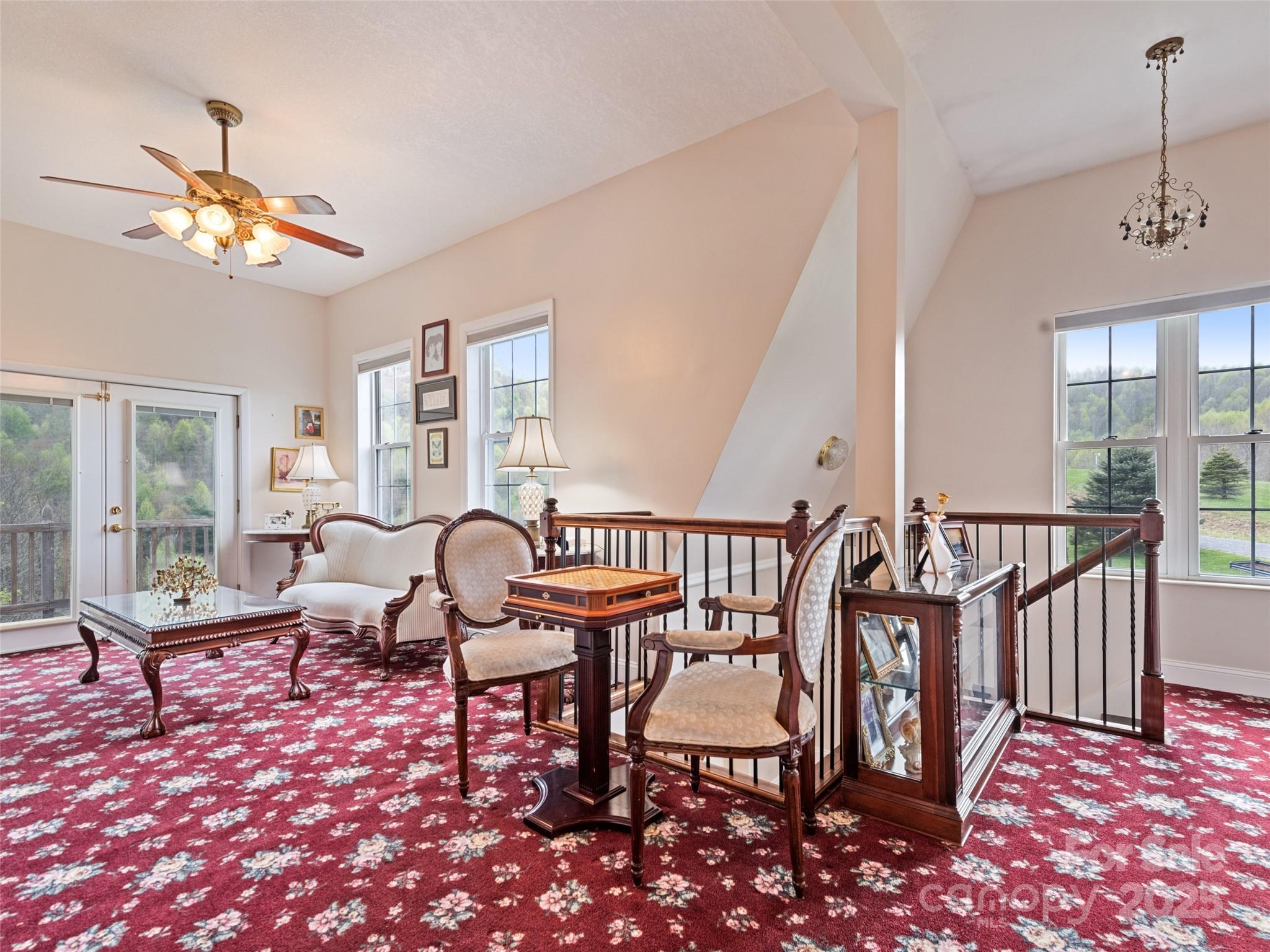 6780 Max Patch Road Clyde, NC 28721 - Photo 16 of 32 a living room with furniture a rug and a chandelier