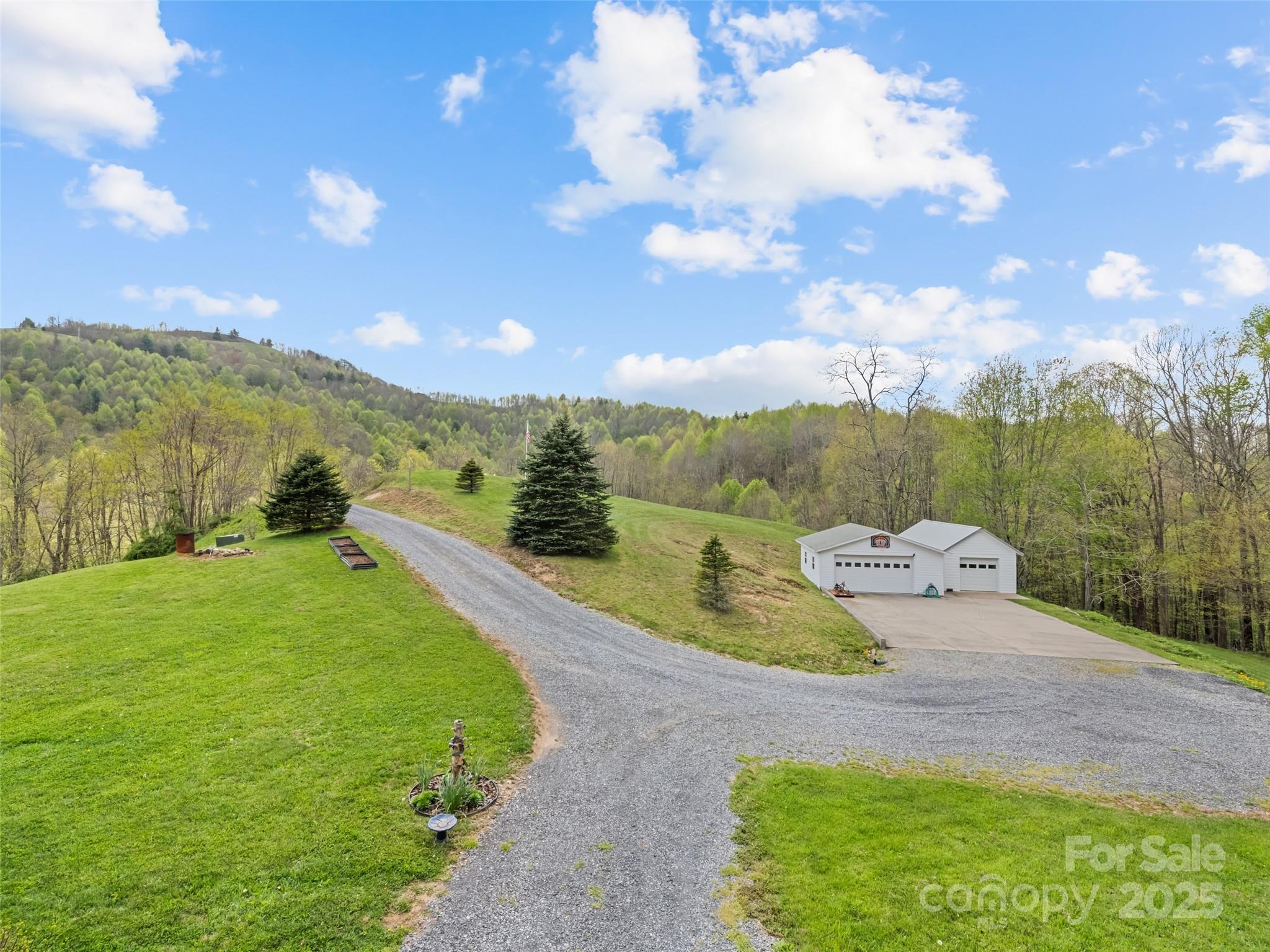 6780 Max Patch Road Clyde, NC 28721 - Photo 25 of 32 a view of a lake with a yard
