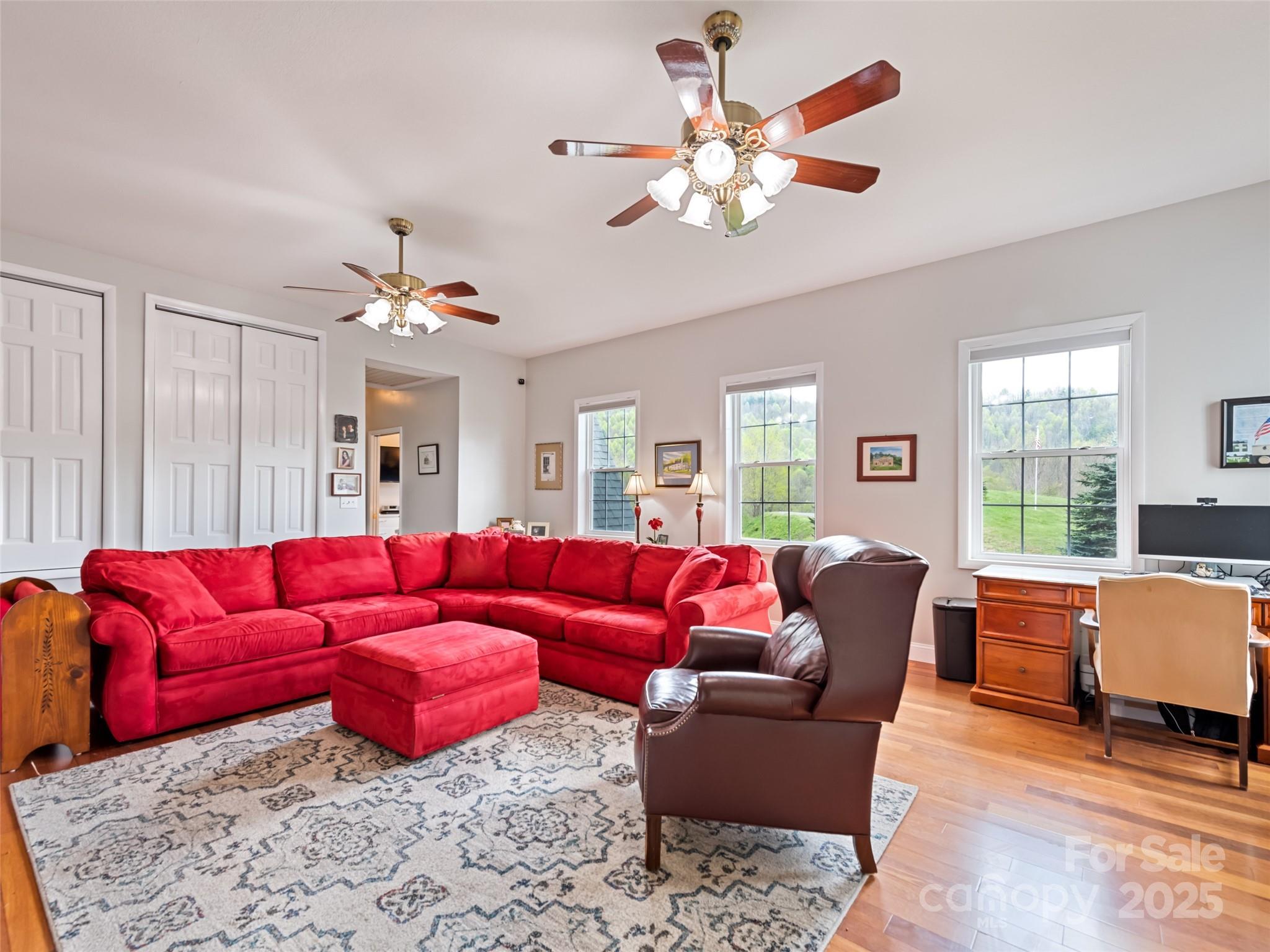 6780 Max Patch Road Clyde, NC 28721 - Photo 10 of 32 a living room with furniture a chandelier and a chandelier
