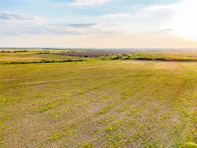 a view of a lake with lawn chairs