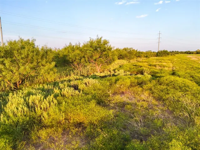 a view of a big yard with an outdoor space and seating area