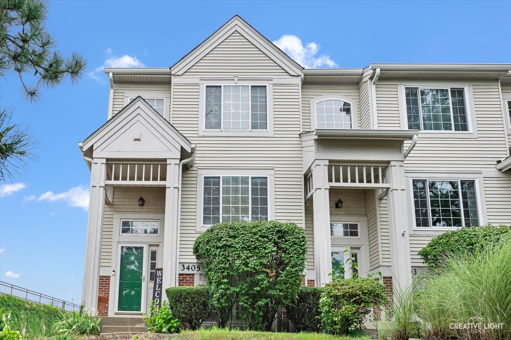 3405 Ravinia Circle, Unit 3405 Aurora, IL 60504 - Photo 1 of 17 a front view of a house with a yard and garage