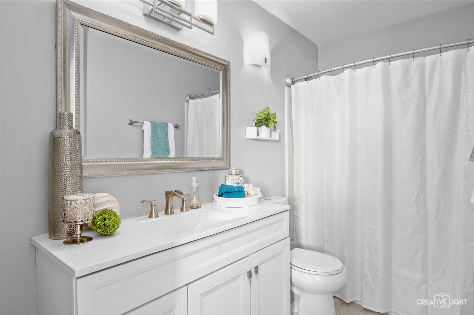 3405 Ravinia Circle, Unit 3405 Aurora, IL 60504 - Photo 13 of 17 a bathroom with a sink a toilet and a mirror