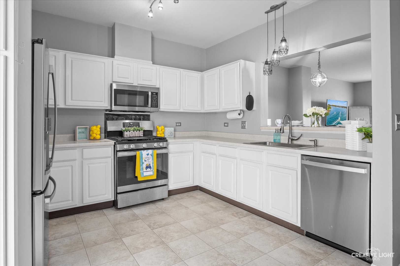 3405 Ravinia Circle, Unit 3405 Aurora, IL 60504 - Photo 6 of 17 a kitchen with stainless steel appliances a refrigerator sink and microwave