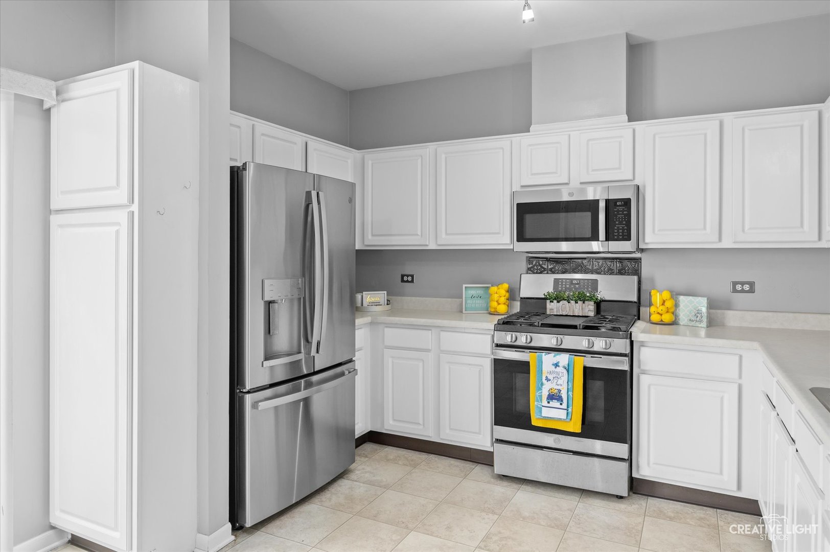 3405 Ravinia Circle, Unit 3405 Aurora, IL 60504 - Photo 7 of 17 a kitchen with cabinets stainless steel appliances and a counter space