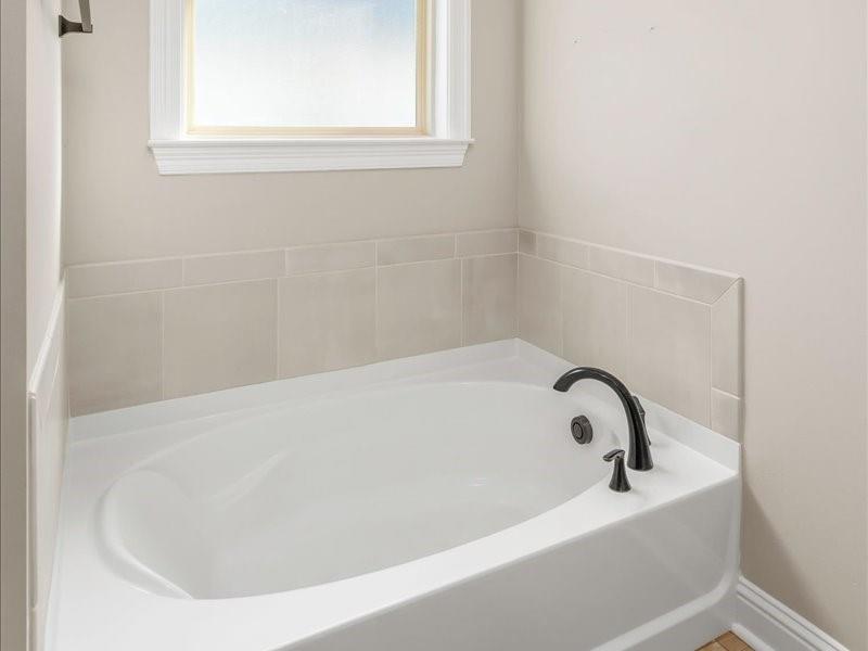 133 Brimestone Loop Benton, LA 71006 - Photo 16 of 32 a white bath tub sitting in a bathroom