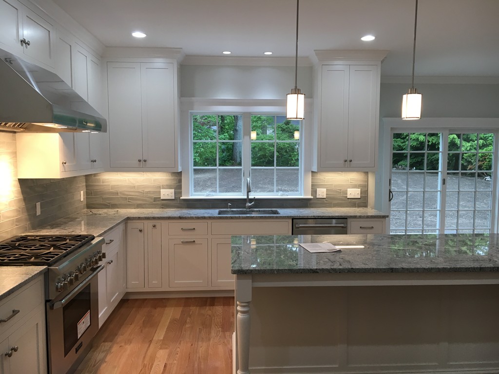 37 Fairview Road Needham, MA 02492 - Photo 6 of 8 a kitchen with kitchen island granite countertop a stove a sink and a granite counter tops
