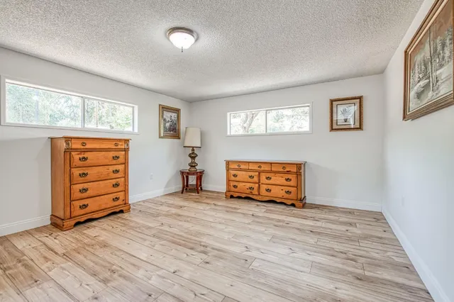 an empty room with furniture and window