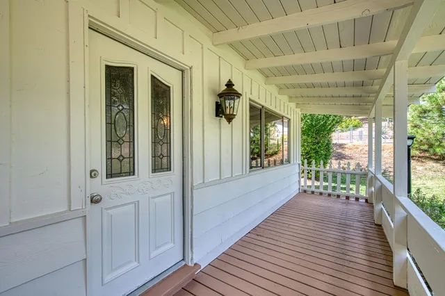 a view of a porch with wooden floor
