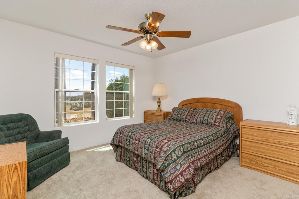 575 Rancho Trail Ramona, CA 92065 - Photo 14 of 47 a bedroom with a bed and a couch