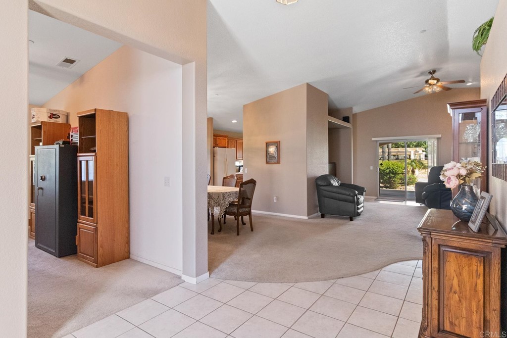 575 Rancho Trail Ramona, CA 92065 - Photo 16 of 47 a living room with furniture a large window and kitchen view