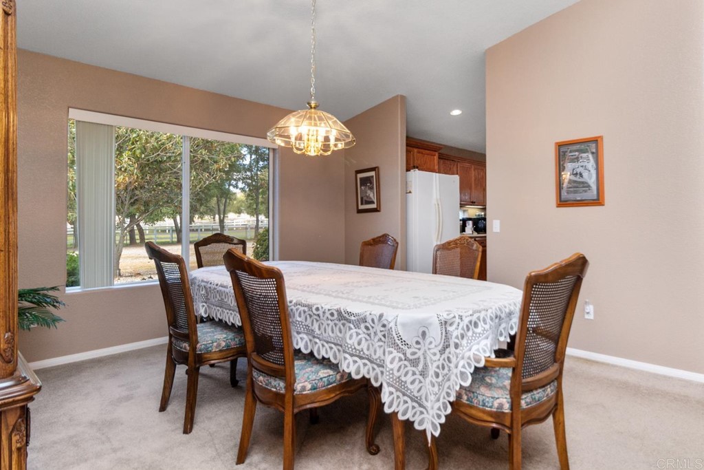 575 Rancho Trail Ramona, CA 92065 - Photo 17 of 47 a dining room with furniture a chandelier and wooden floor