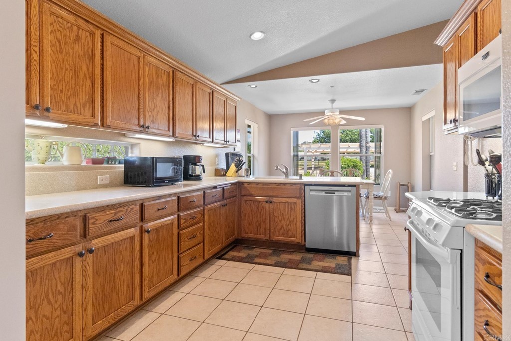 575 Rancho Trail Ramona, CA 92065 - Photo 19 of 47 a kitchen with a stove sink and cabinets