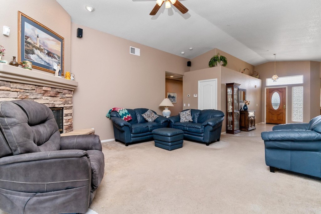 575 Rancho Trail Ramona, CA 92065 - Photo 24 of 47 a living room with furniture a couch and a chandelier