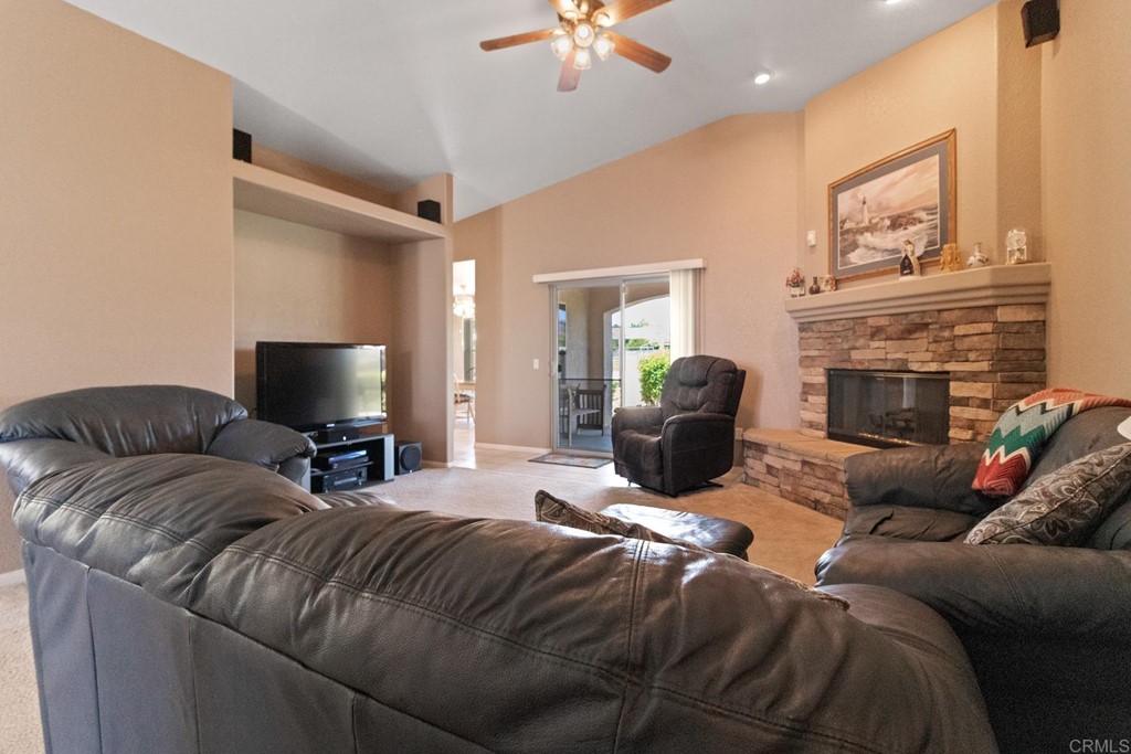 575 Rancho Trail Ramona, CA 92065 - Photo 25 of 47 a living room with furniture a fireplace and a ceiling fan